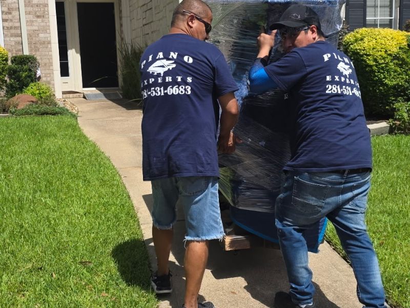crew moving a piano betton moving company