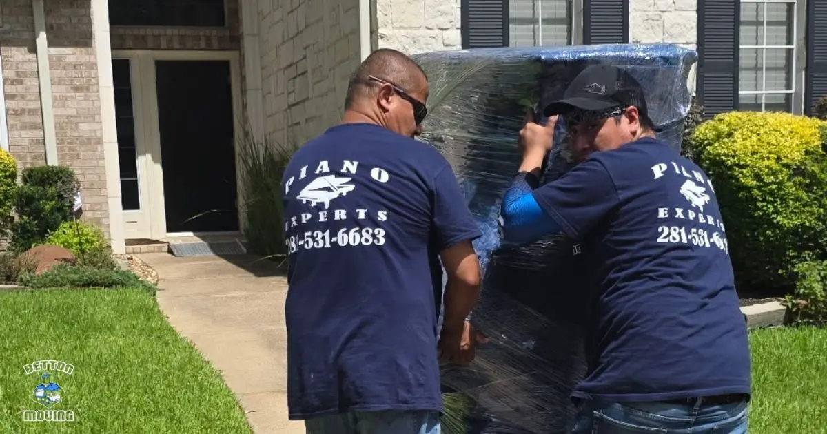 Betton Moving Company crew preparing a piano for a move